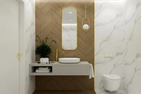 Elegancka łazienka z umywalką, złotą baterią i wiszącą toaletą. Centralnym punktem jest owalne lustro łazienkowe w złotej ramie, wiszące na drewnianej ścianie.