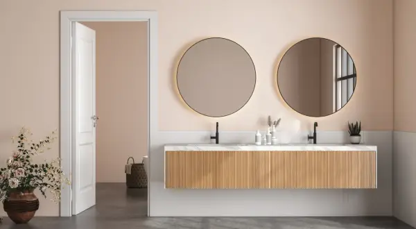 Elegancka łazienka z dwoma okrągłymi, podświetlanymi lustrami, które stanowią oryginalne lustra do łazienki.