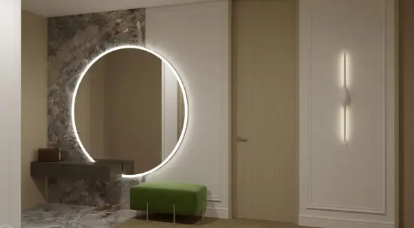 Eleganckie, duże lustro do przedpokoju z podświetleniem LED, wiszące nad ciemną konsolą. Obok zielona pufa i drzwi.